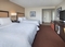 Hampton Inn JFK - The standard room with two queen beds has plush bedding so you can stretch out and relax with comfort. The room includes free WiFi, a coffee maker, and a large desk and chair.