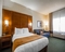 Comfort Suites Appleton Airport - A standard room with a king bed includes a flat screen TV, desk, coffee maker, refrigerator, microwave, hair dryer, sleeper sofa, iron, and ironing board.