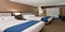 Holiday Inn Austin Airport - The standard room with two queen beds includes a flat screen TV, free WIFI, refrigerator, and coffee maker.