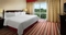 Hilton Charlotte Airport Hotel - The standard room with a king size bed has a separate living room with a sleeper sofa, 55
