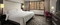 Embassy Suites Crystal City - The standard room with a king size bed has a separate living room with a sleeper sofa, a microwave, and mini refrigerator.